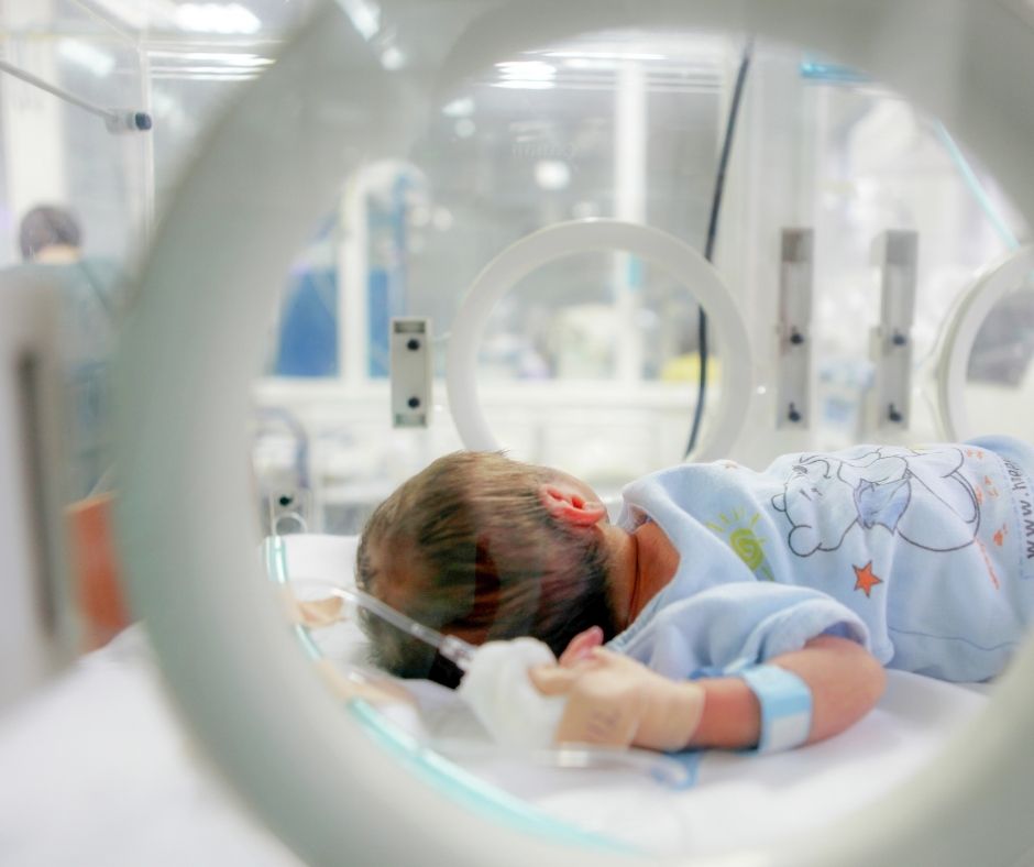 side view of baby in warmer in nicu, tips for parents with baby in nicu
