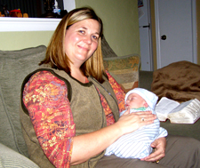 Image of Woman: Kristy Huber postpartum doula holding a newborn baby